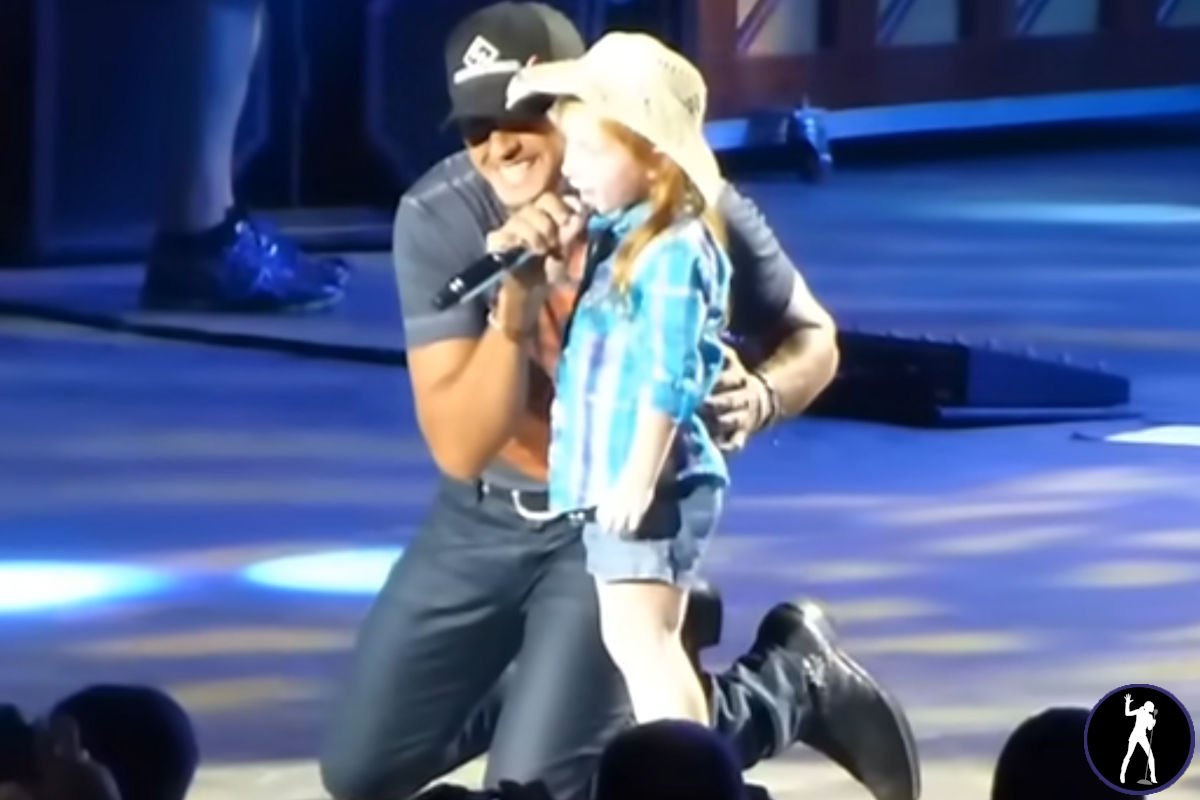 luke bryan brings a young fan onstage to sing a duet