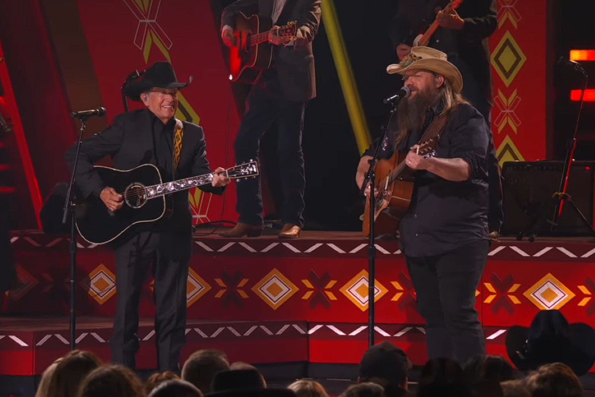 george strait and chris stapleton on stage singing and playing guitar