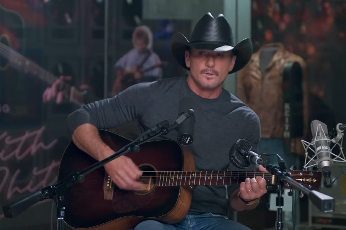 Tim McGraw singing and playing guitar in a studio