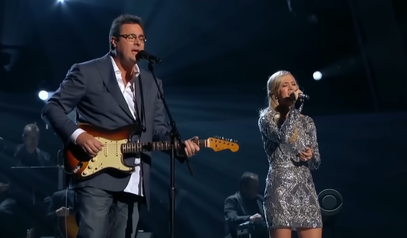 Carrie Underwood and Vince Gill performing together on stage