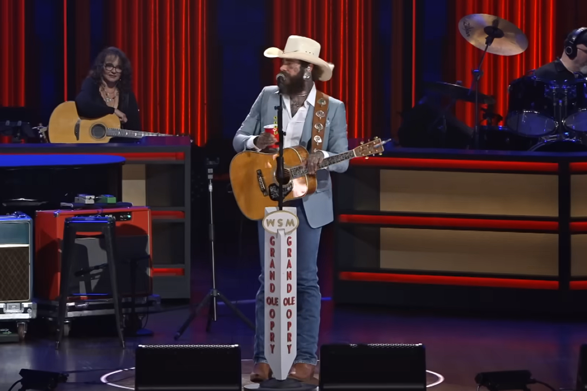 post malone talking into a microphone at the grand ole opry