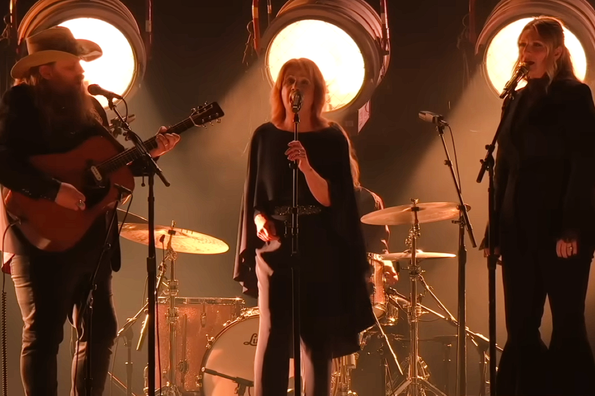 Chris Stapleton and Patty Loveless performing together on stage