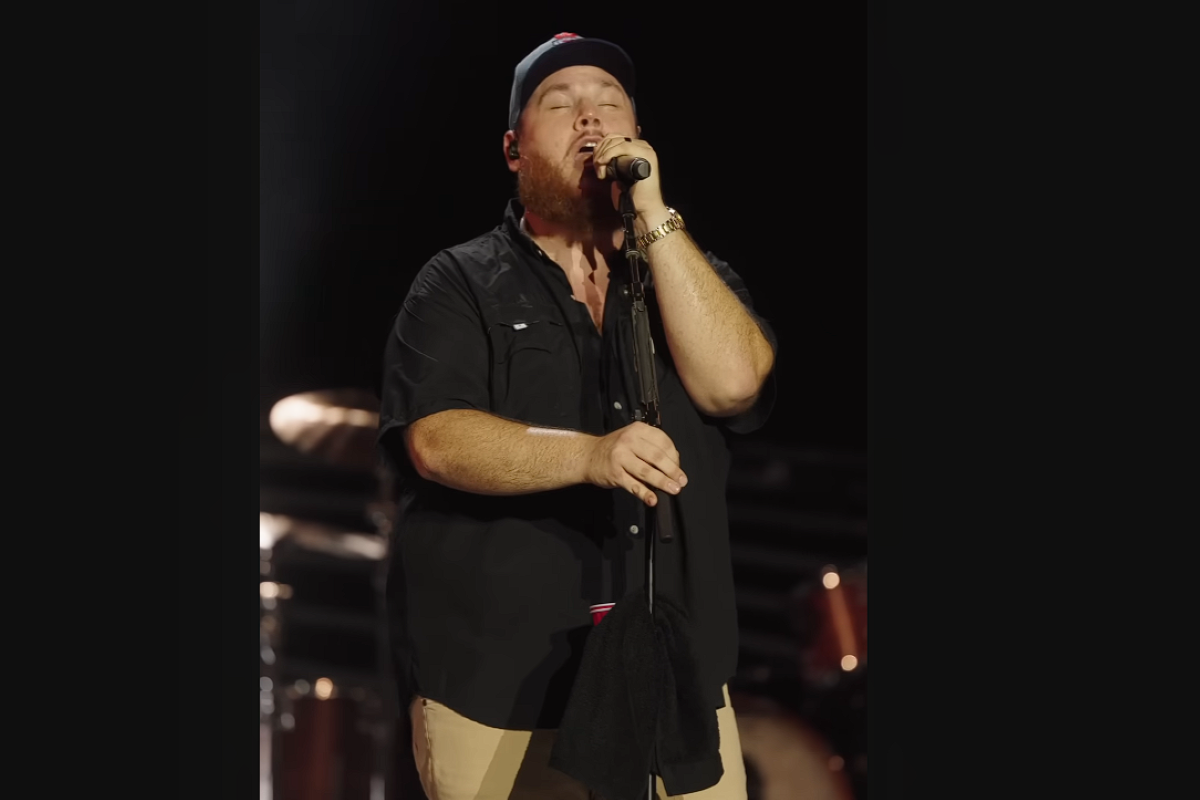 Luke Combs singing "Wish Upon A Whiskey" at a concert