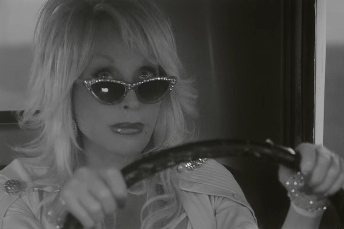 Dolly Parton driving in a music video