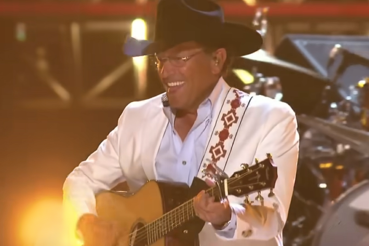 George Strait singing and playing guitar