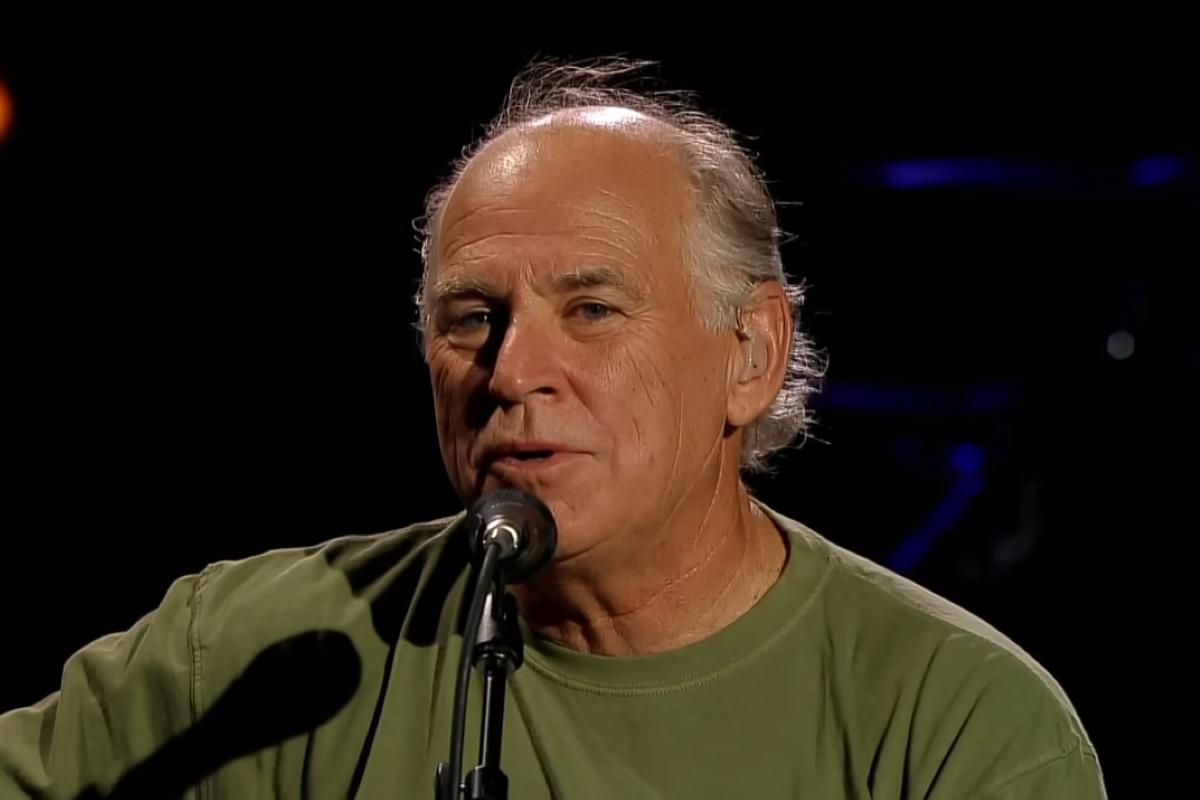 Jimmy Buffett singing into a microphone