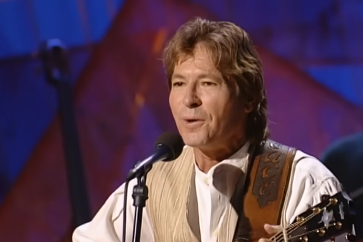 John Denver singing into microphone